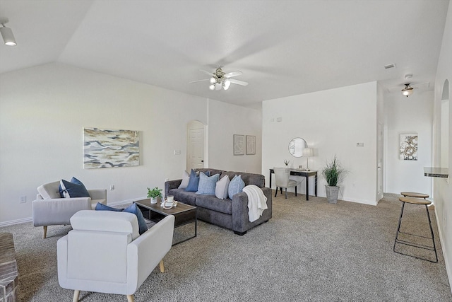 living room with ceiling fan, vaulted ceiling, and carpet