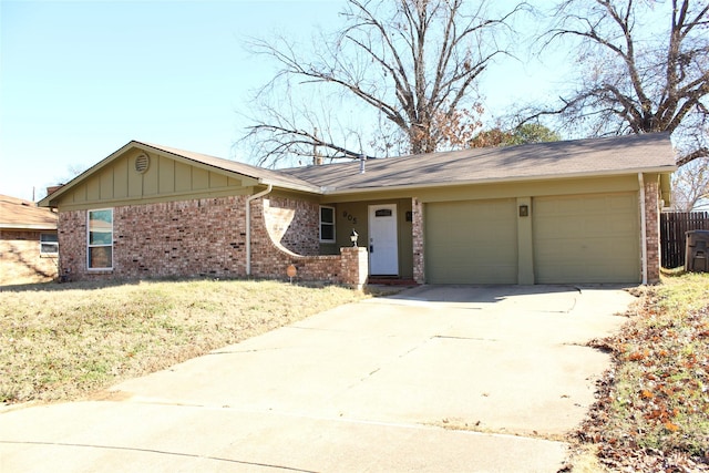 ranch-style home with a garage and a front yard