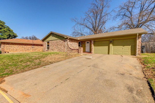 ranch-style house featuring a garage and a front lawn