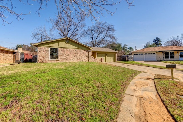 ranch-style house with a garage and a front lawn