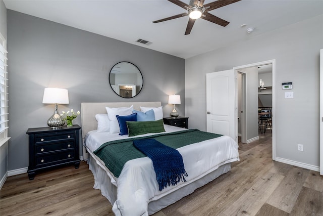 bedroom with ceiling fan and hardwood / wood-style flooring