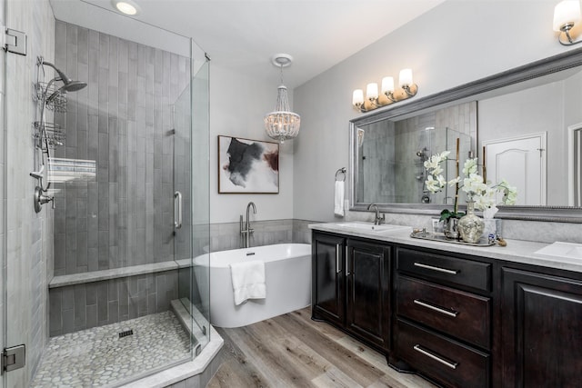 bathroom featuring wood-type flooring, vanity, and independent shower and bath