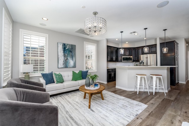 living room featuring dark hardwood / wood-style floors and a notable chandelier