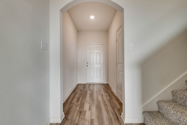 corridor with light hardwood / wood-style floors