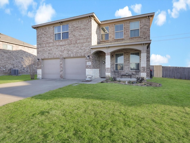 view of front of house with a front yard, covered porch, and a garage