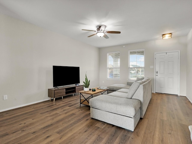 living room featuring ceiling fan and hardwood / wood-style flooring