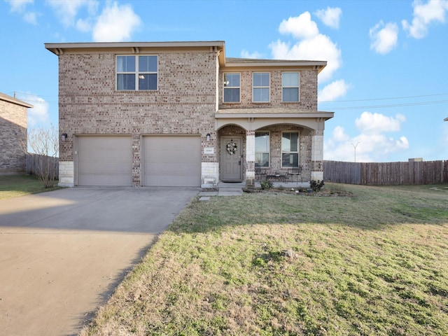 view of front property with a garage, a front yard, and covered porch