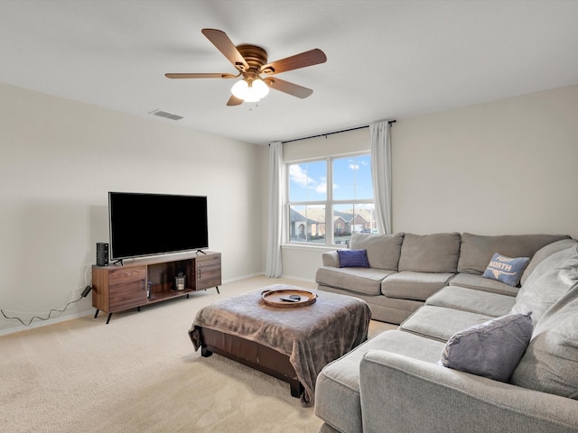 carpeted living room with ceiling fan