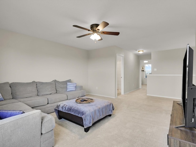 carpeted living room with ceiling fan