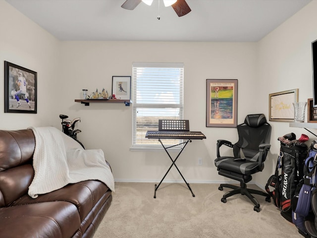 carpeted home office featuring ceiling fan