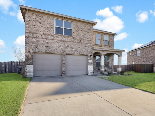 front facade featuring a garage and a front lawn