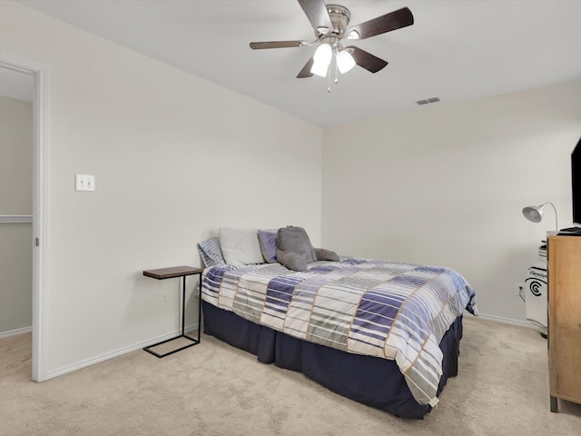 bedroom with ceiling fan and light colored carpet