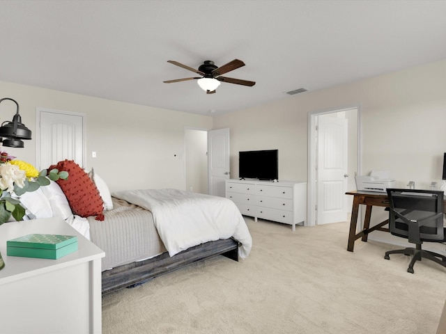 bedroom with ceiling fan and light carpet