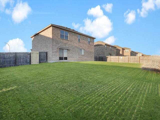 back of house featuring a yard