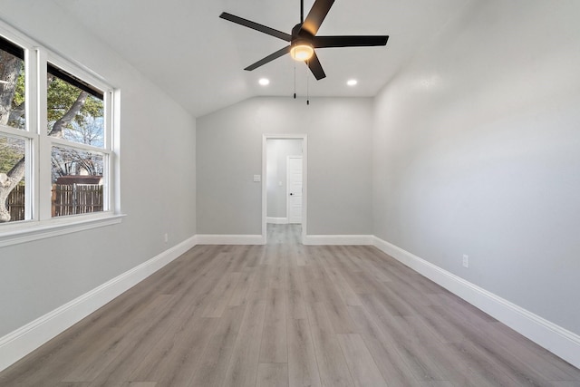 spare room featuring ceiling fan, light hardwood / wood-style floors, and lofted ceiling