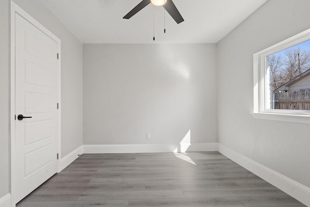 unfurnished room with ceiling fan and wood-type flooring