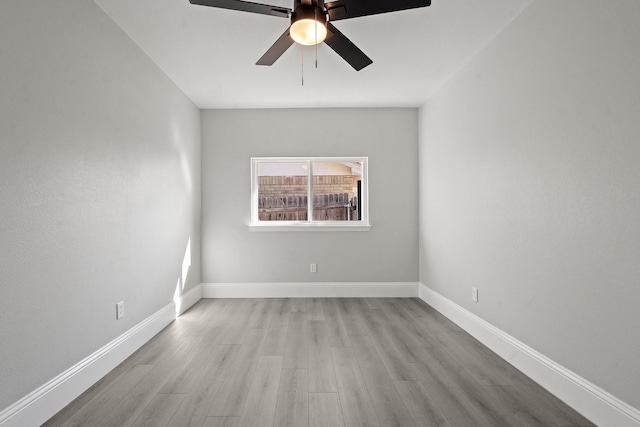 unfurnished room featuring light wood-type flooring and ceiling fan