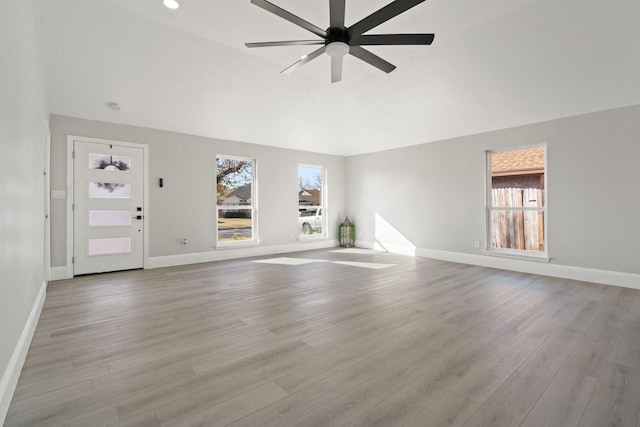 unfurnished living room featuring ceiling fan and light wood-type flooring