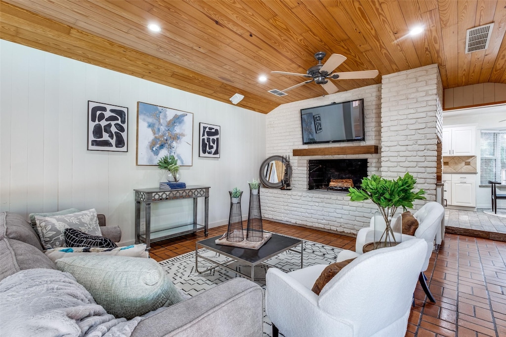 living room featuring a fireplace, ceiling fan, and wood ceiling