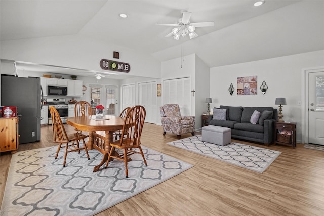 dining area featuring ceiling fan, light hardwood / wood-style flooring, and lofted ceiling