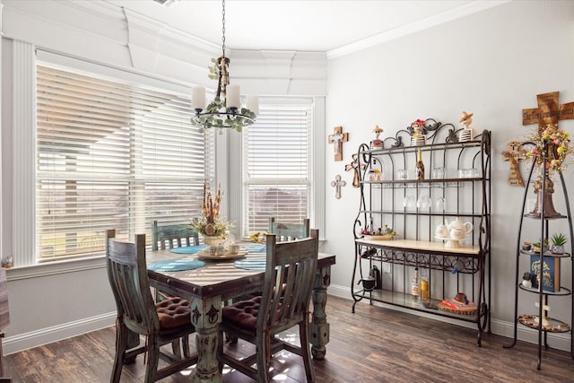 dining space featuring dark wood-type flooring, crown molding, and a chandelier