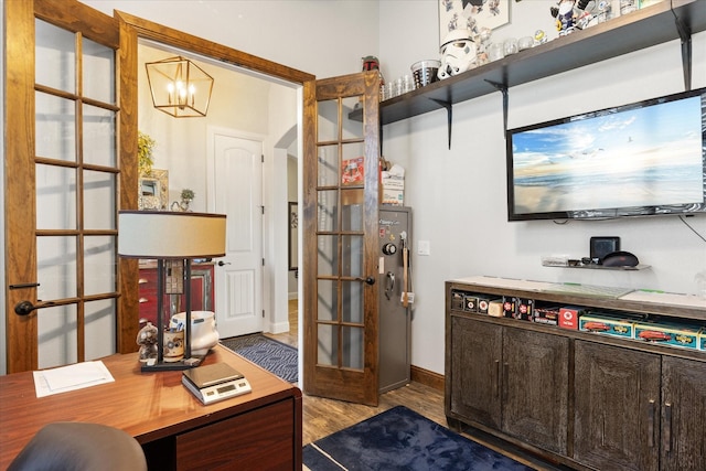 office featuring an inviting chandelier, light hardwood / wood-style floors, and french doors