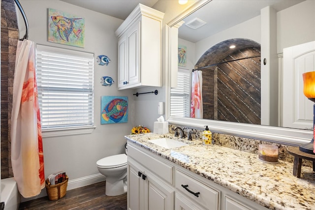 full bathroom featuring shower / bath combo with shower curtain, wood-type flooring, toilet, and vanity