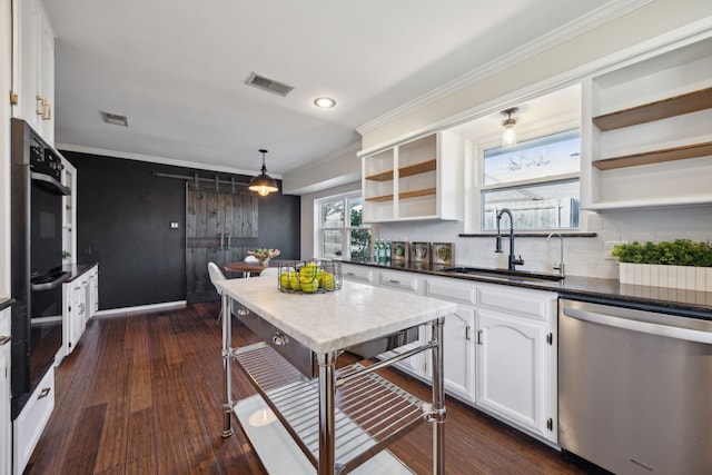 kitchen with stainless steel dishwasher, decorative backsplash, sink, dark wood-type flooring, and white cabinets