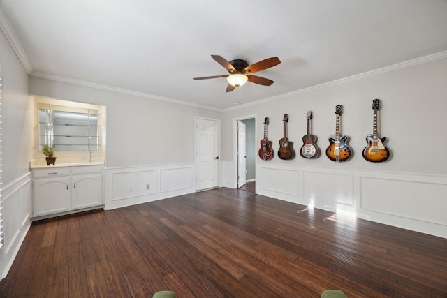 unfurnished room featuring ceiling fan, crown molding, and dark hardwood / wood-style floors