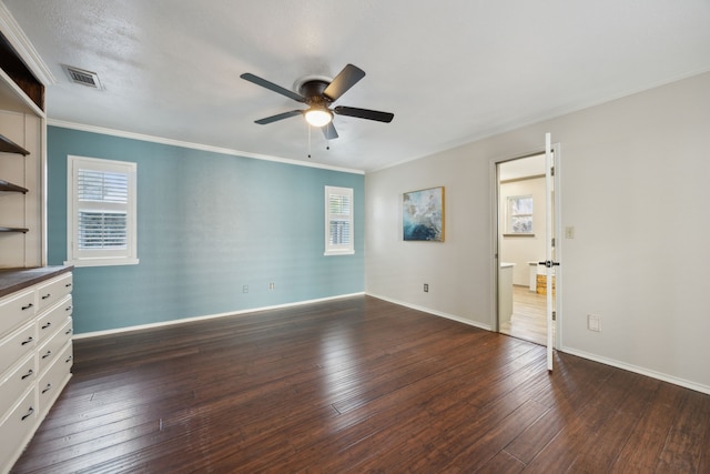 spare room with ceiling fan, dark hardwood / wood-style floors, ornamental molding, and a textured ceiling