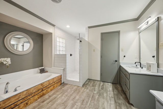 bathroom with separate shower and tub, vanity, wood-type flooring, and crown molding