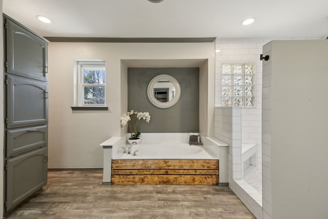 bathroom featuring hardwood / wood-style floors and shower with separate bathtub