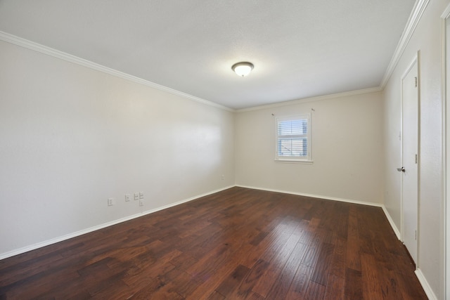 spare room featuring dark wood-type flooring and ornamental molding