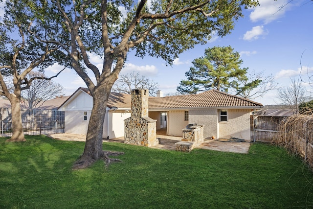 rear view of property with a patio area and a lawn