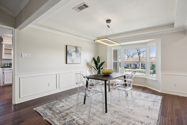 dining area with dark wood-type flooring and ornamental molding