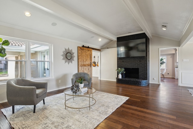 living room with vaulted ceiling with beams, dark hardwood / wood-style floors, and a barn door