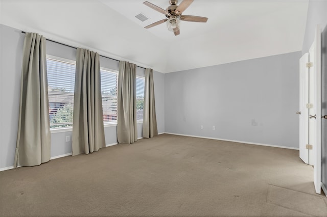 spare room with light carpet, vaulted ceiling, and ceiling fan