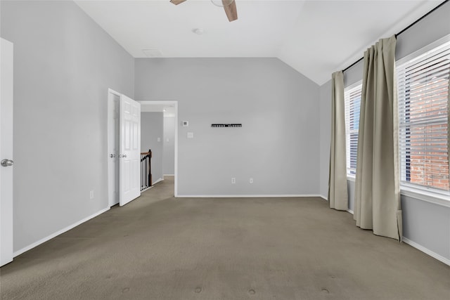 unfurnished bedroom featuring vaulted ceiling, ceiling fan, and carpet flooring