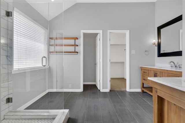 bathroom with vaulted ceiling, an enclosed shower, and vanity