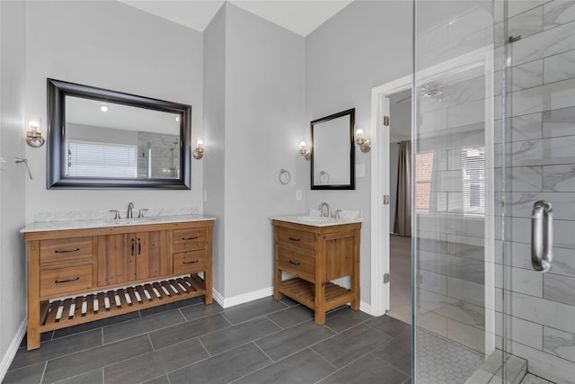 bathroom featuring tile patterned floors, a wealth of natural light, a shower with shower door, and vanity