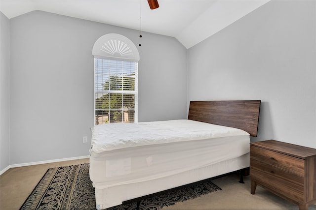 bedroom featuring ceiling fan, vaulted ceiling, and carpet