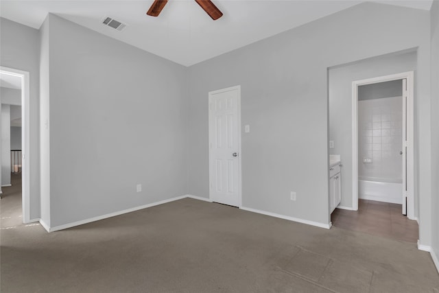 unfurnished bedroom featuring ceiling fan, a closet, carpet, and connected bathroom