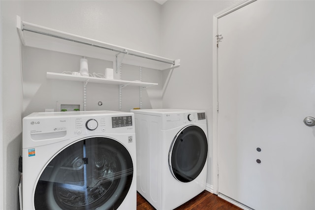 laundry area with dark hardwood / wood-style flooring and washing machine and clothes dryer