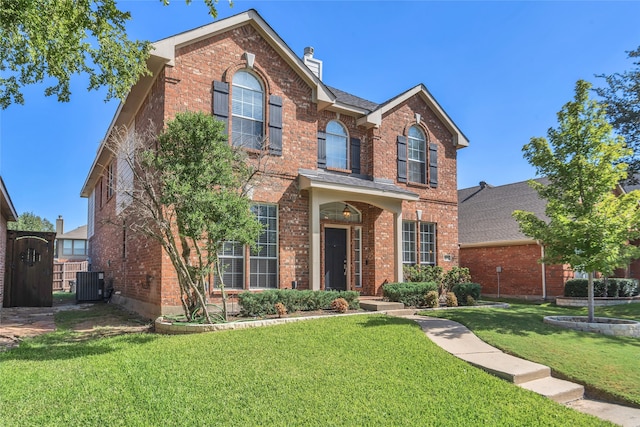 front of property with a front lawn and central AC