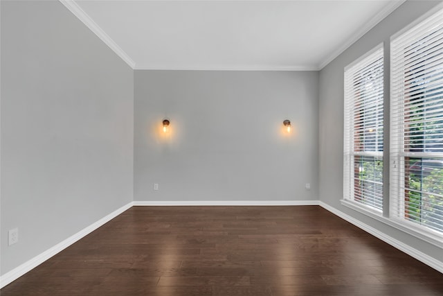 spare room featuring dark hardwood / wood-style flooring and ornamental molding