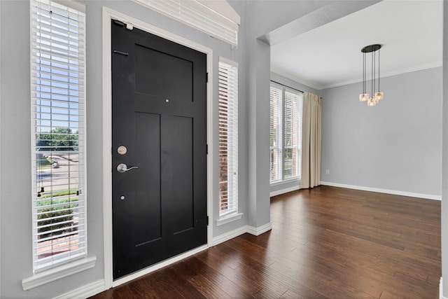 foyer featuring dark wood-type flooring and ornamental molding