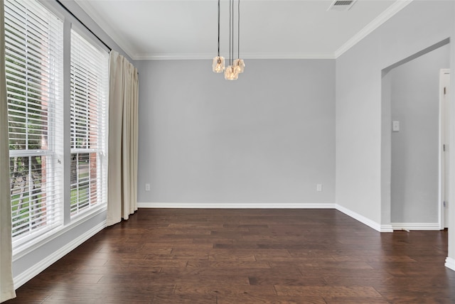 unfurnished dining area with plenty of natural light, dark hardwood / wood-style floors, ornamental molding, and a notable chandelier