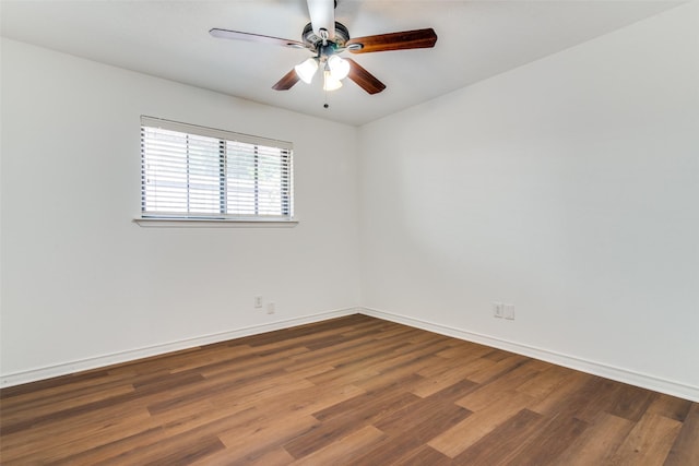 empty room with dark hardwood / wood-style flooring