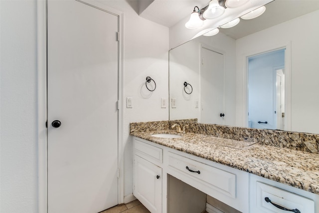 bathroom with tile patterned floors and vanity