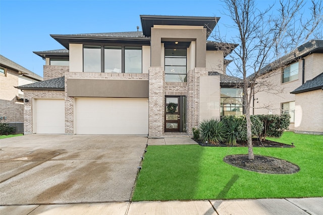 view of front of house featuring a garage and a front yard